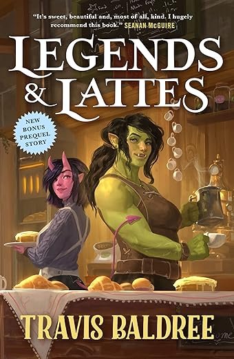 Illustrated book cover of “Legends & Lattes” by Travis Baldree features a smiling orc barista serving coffee. A cheerful ambiance with pastries is visible.